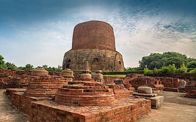 The brick Dhamek Stupa at Sarnath above the excavated monastery ruins